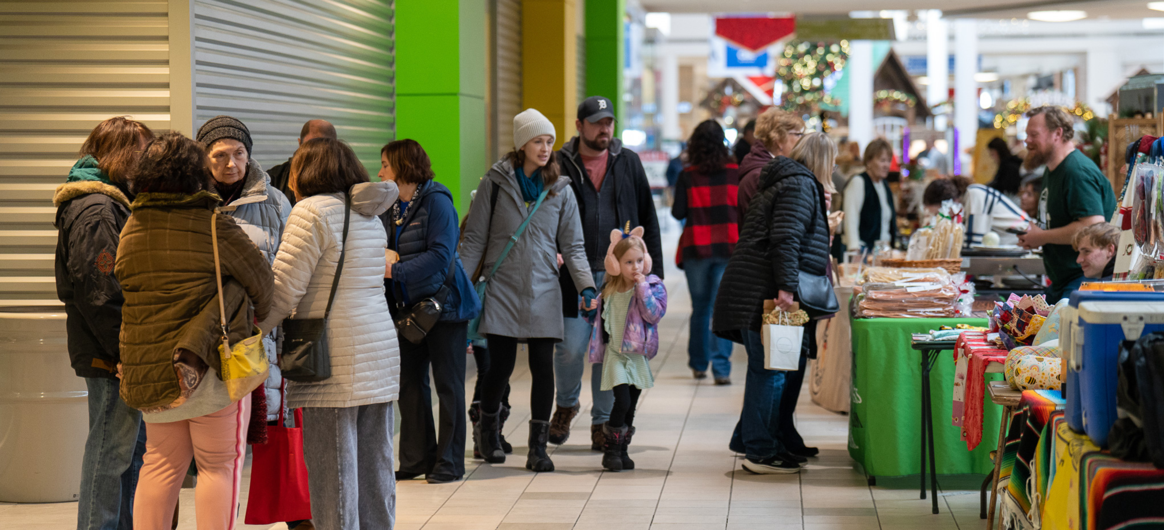 People shopping at indoor farmers market