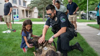 Meridian Township Police officer with K9 Officer Reno at a community event